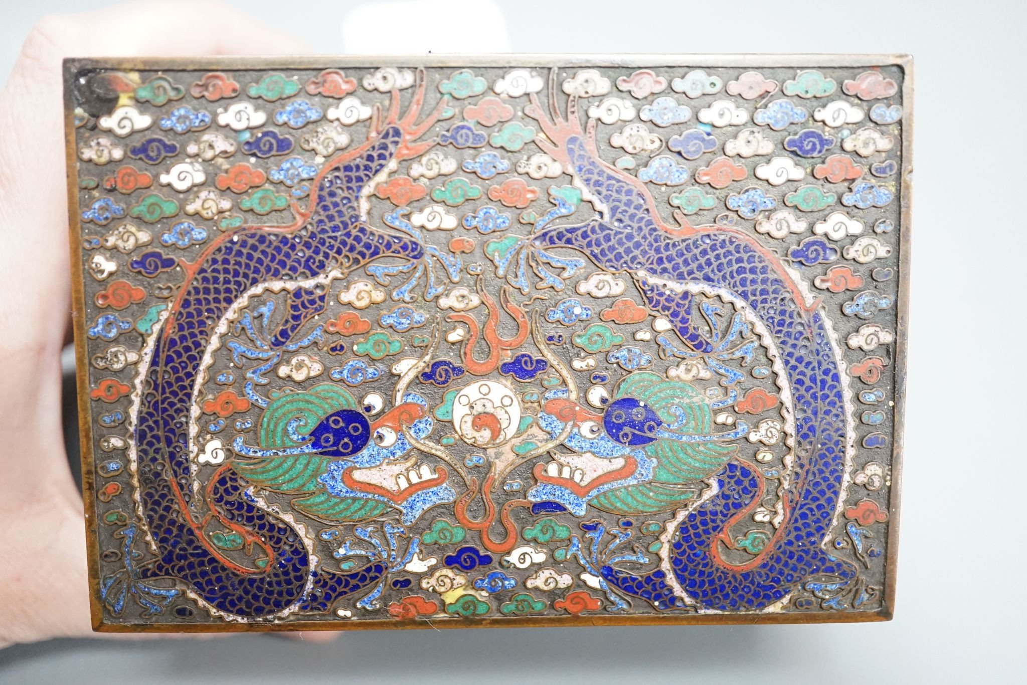 A Chinese bronze and cloisonné enamel ‘dragon’ box and cover, early 20th century, 6 cms high x 11.5 cms wide.